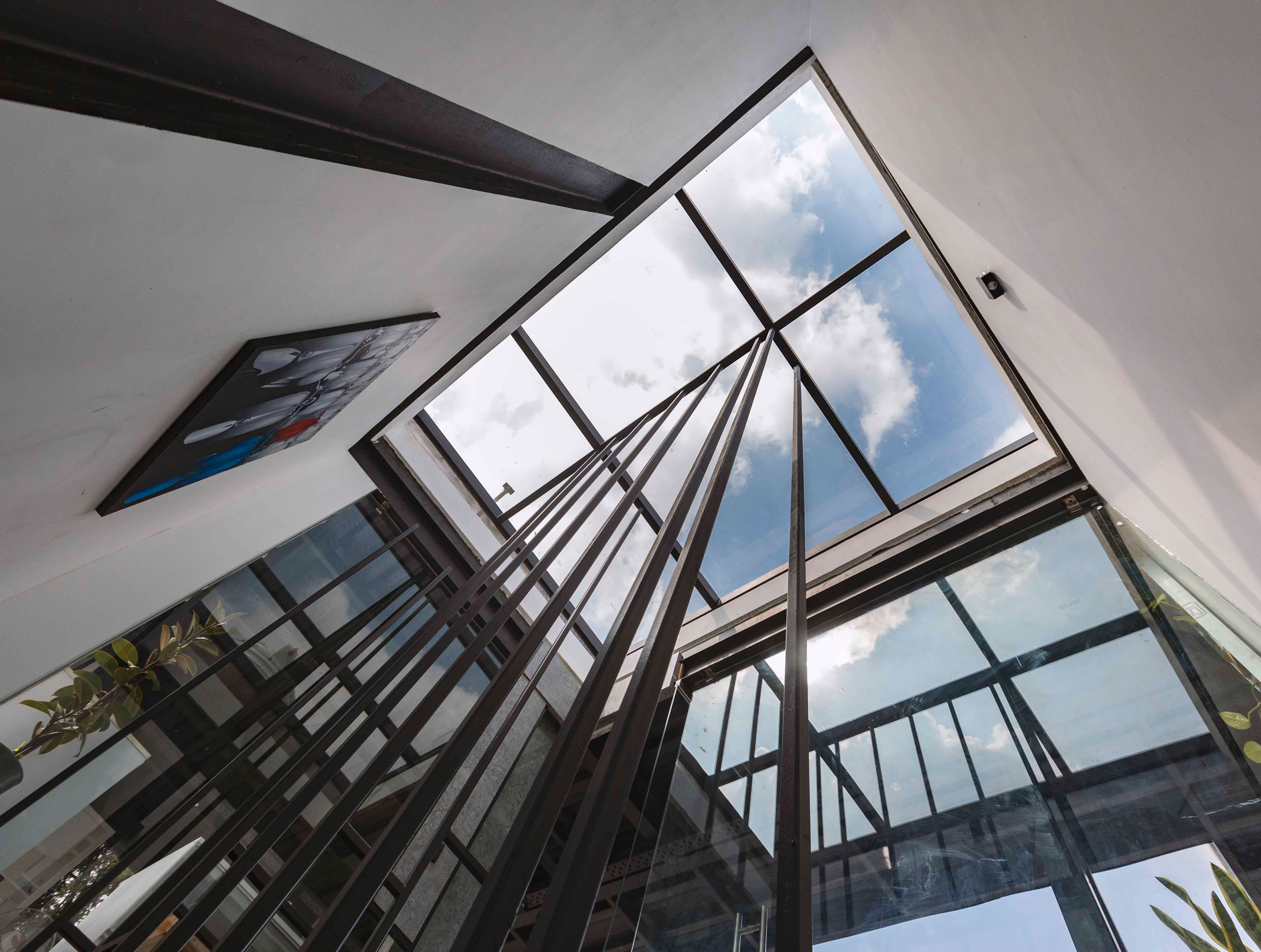 The lightweight floating stairway connecting the office space to the terrace area acts as one of the highlights of the workspace interior.