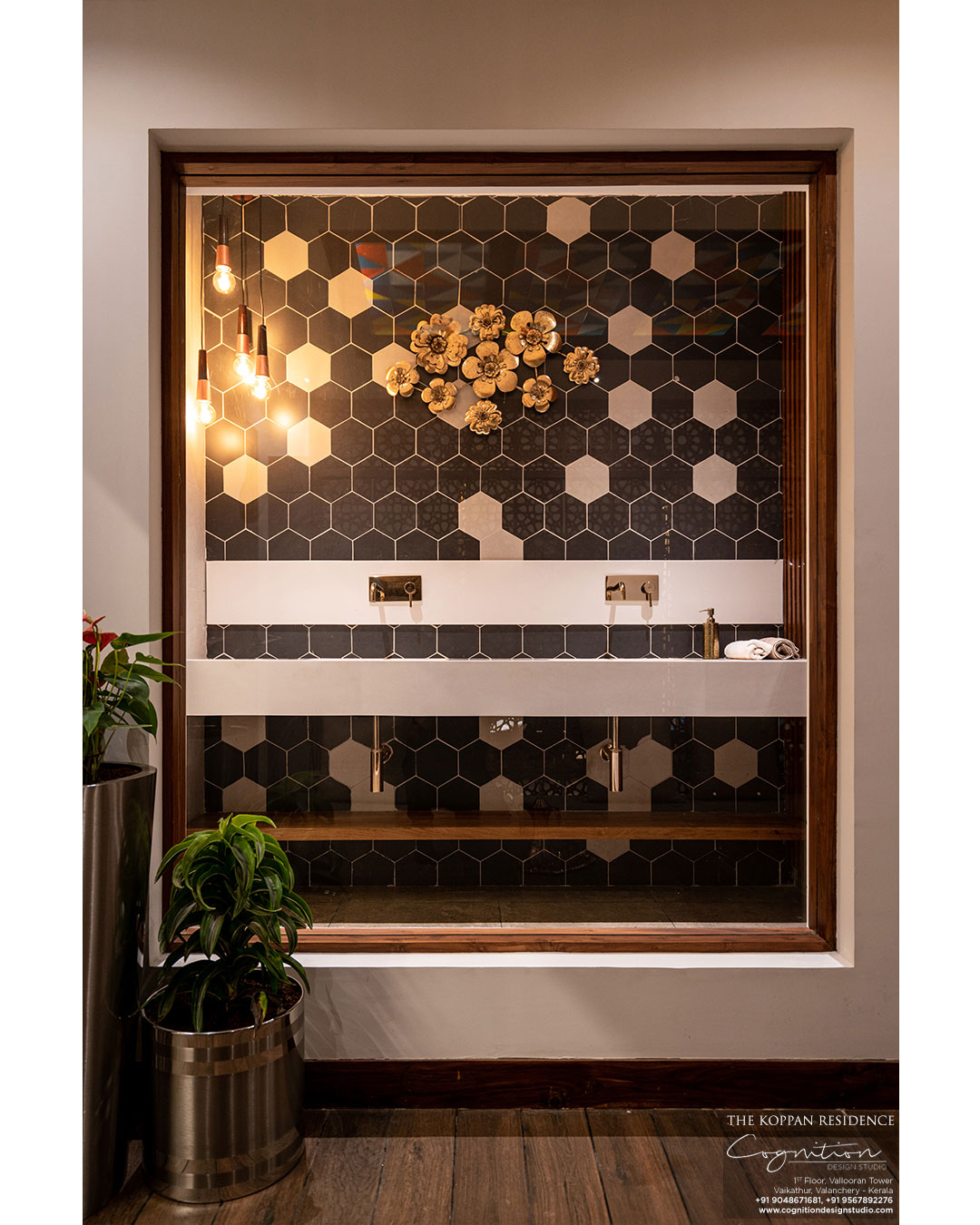 The wash area - The wash basin is custom made and finished in Corian. Other elements include a gold finished faucet and a honeyoomb patterned wall.