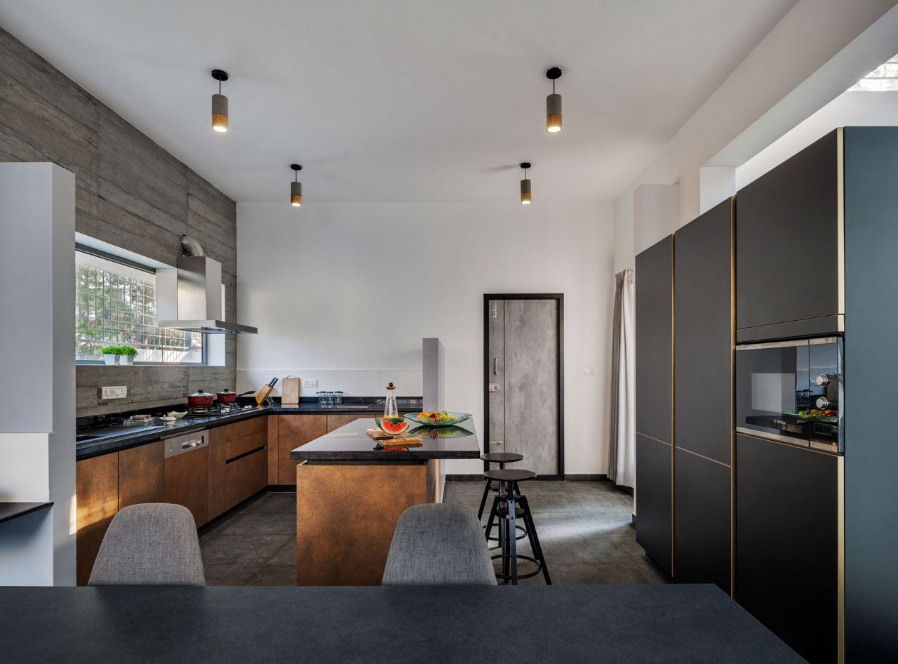 Rustic finished modular kitchen unit with a breakfast counter and adjacent dining area.