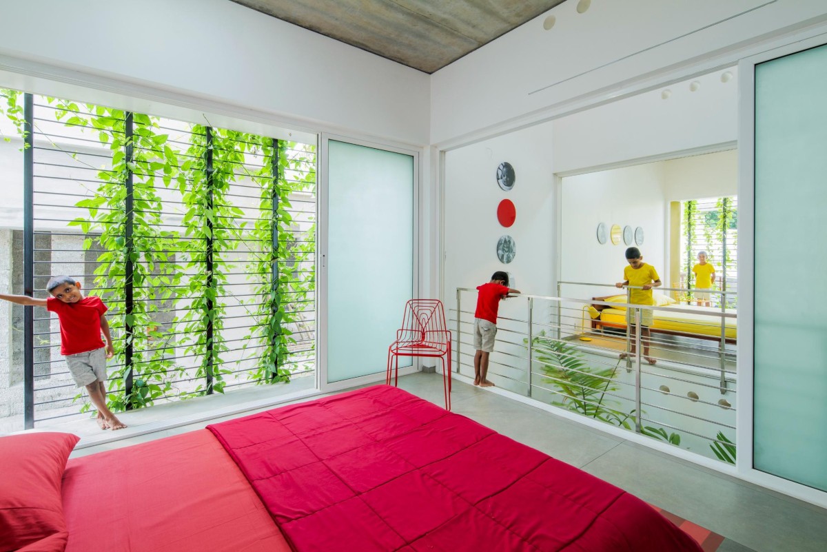 First Floor Red Bedroom of The House That Rains Light by LIJO.RENY.Architects