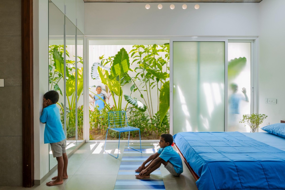 Ground Floor Blue Bedroom of The House That Rains Light by LIJO.RENY.Architects