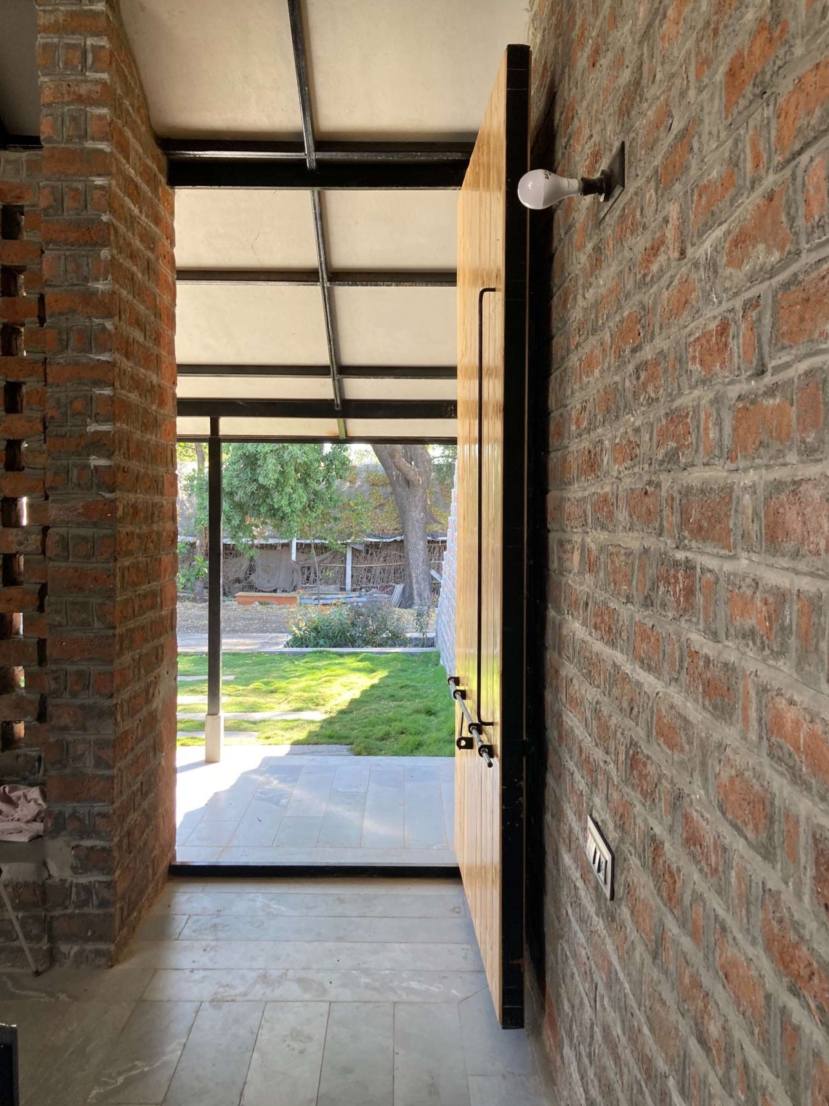 Entrance of Half Is More – House in Progress by Atelier Shantanu Autade + Studio Boxx