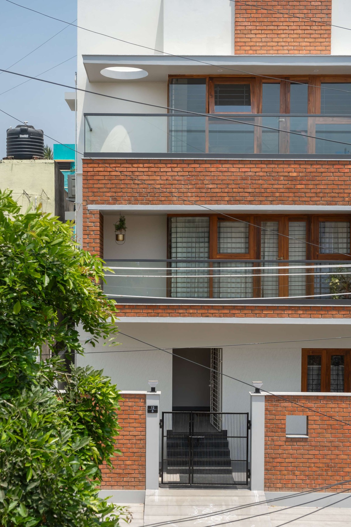 The lower part of the house is defined by rich brickwork, infusing warmth into its design