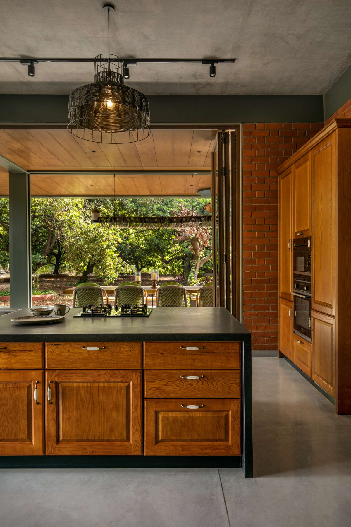 Kitchen of Nirmal Farmhouse by Dipen Gada & Associates