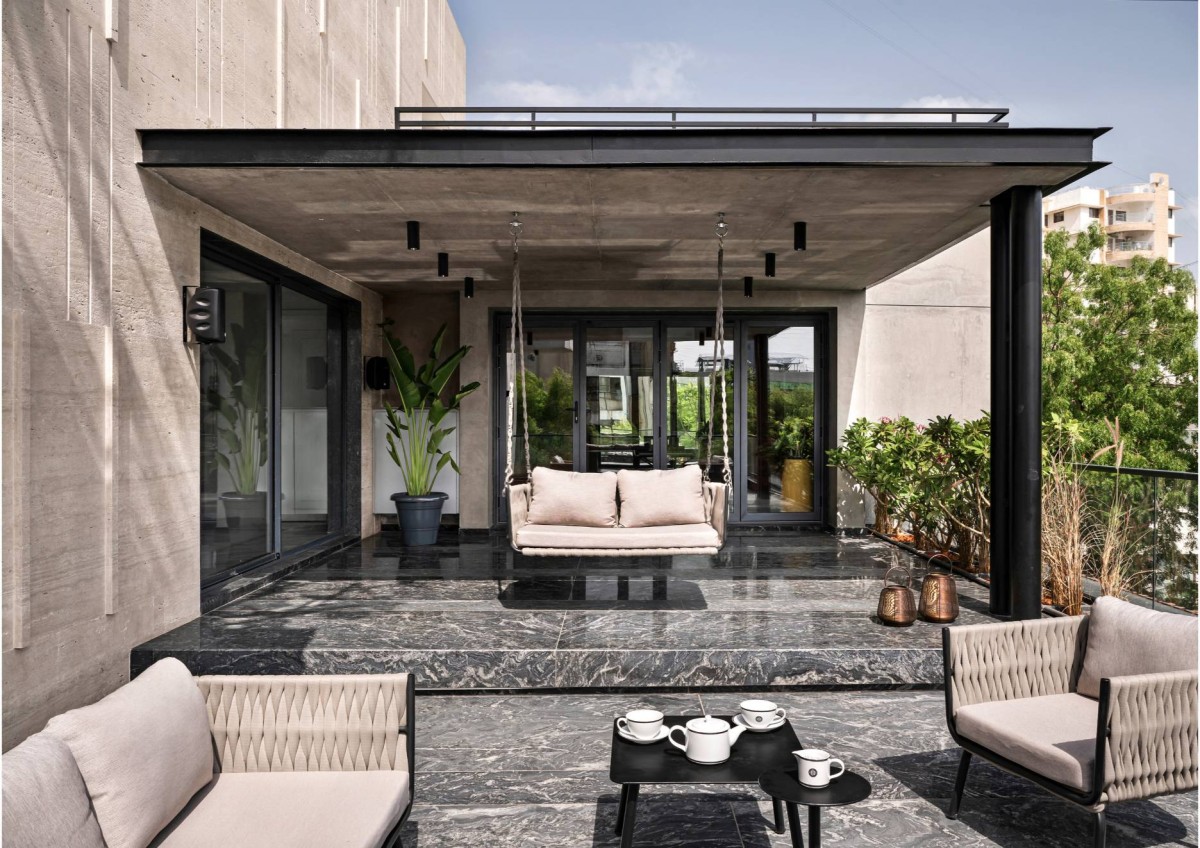 Seating area at terrace of The Roots to Roof Villa by Tvasttr Architects