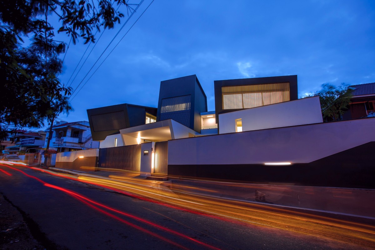 Night shot of exterior view of The Skewed House by LIJO.RENY.architects