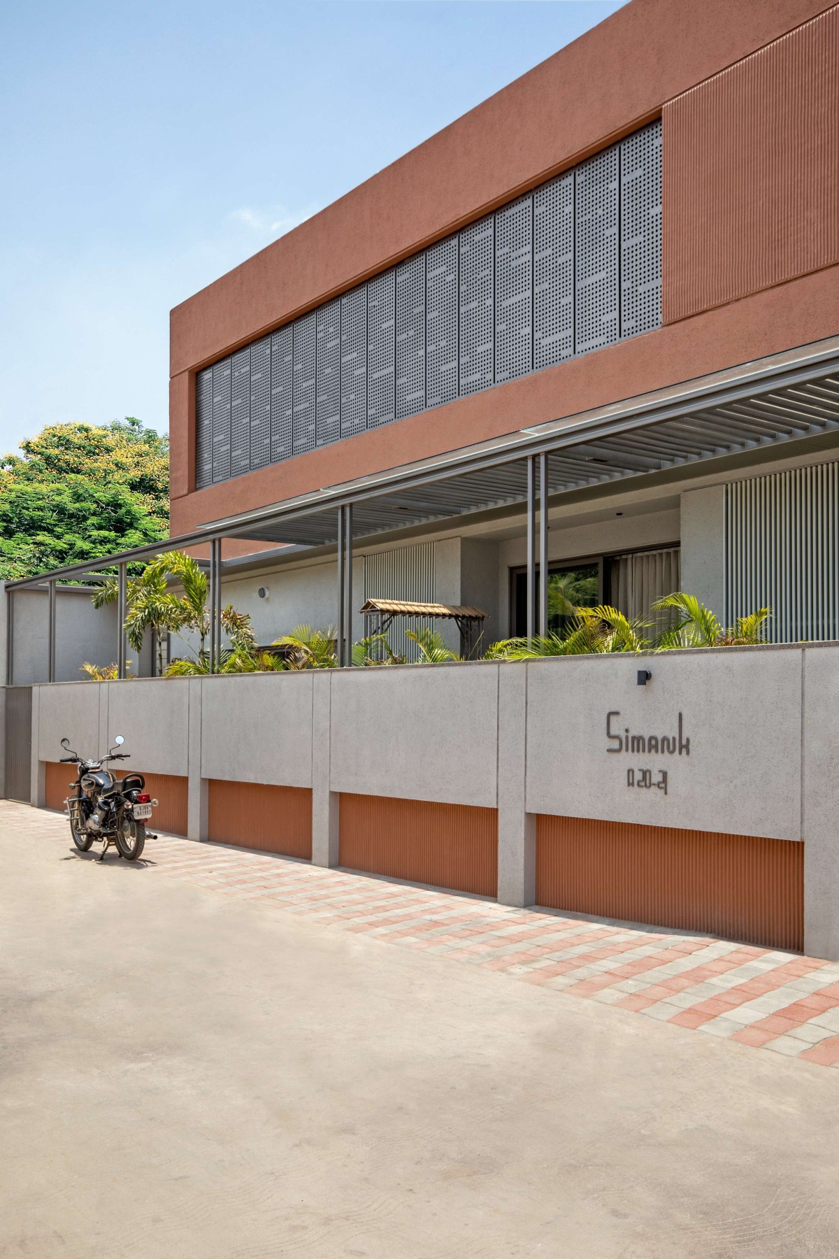 Exterior view of 16 Screens House by A+T Associates