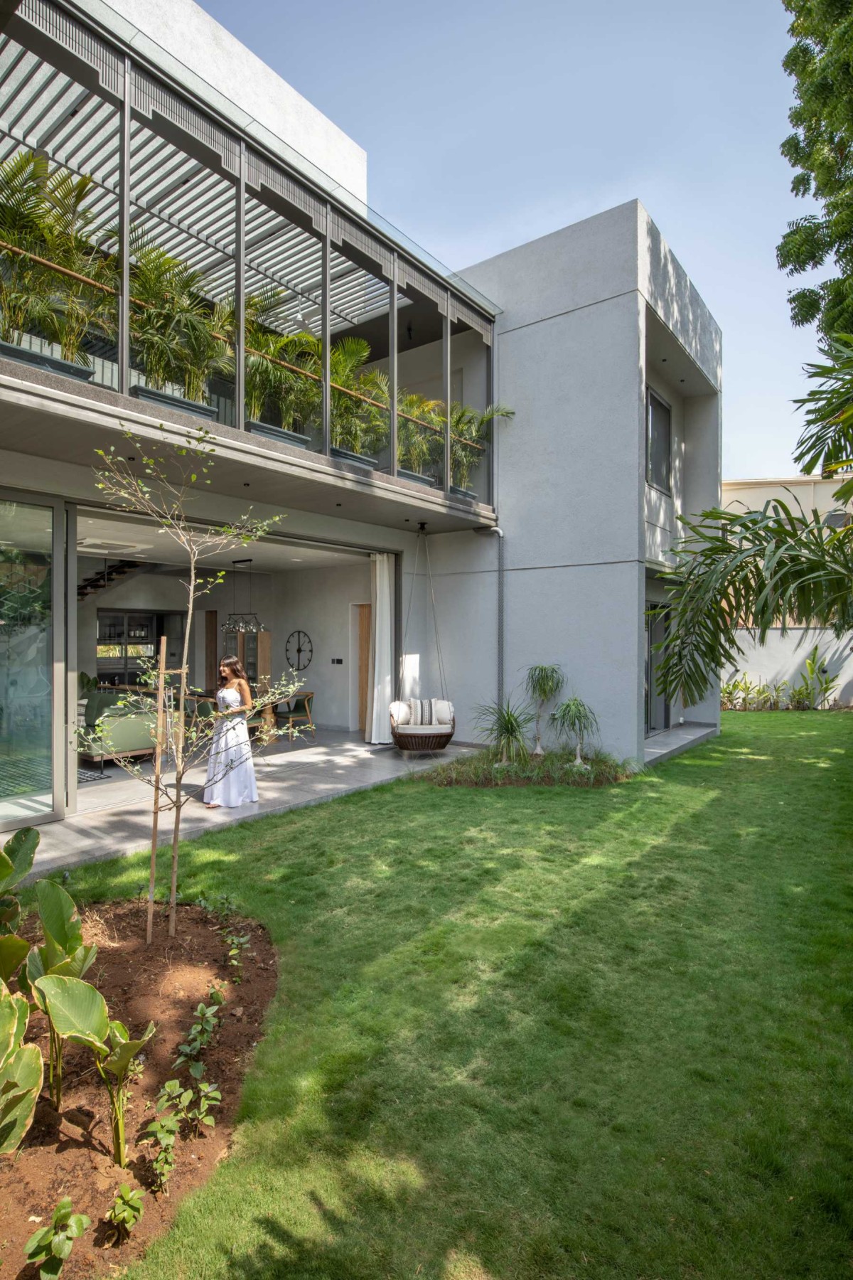 Backyard garden of 16 Screens House by A+T Associates