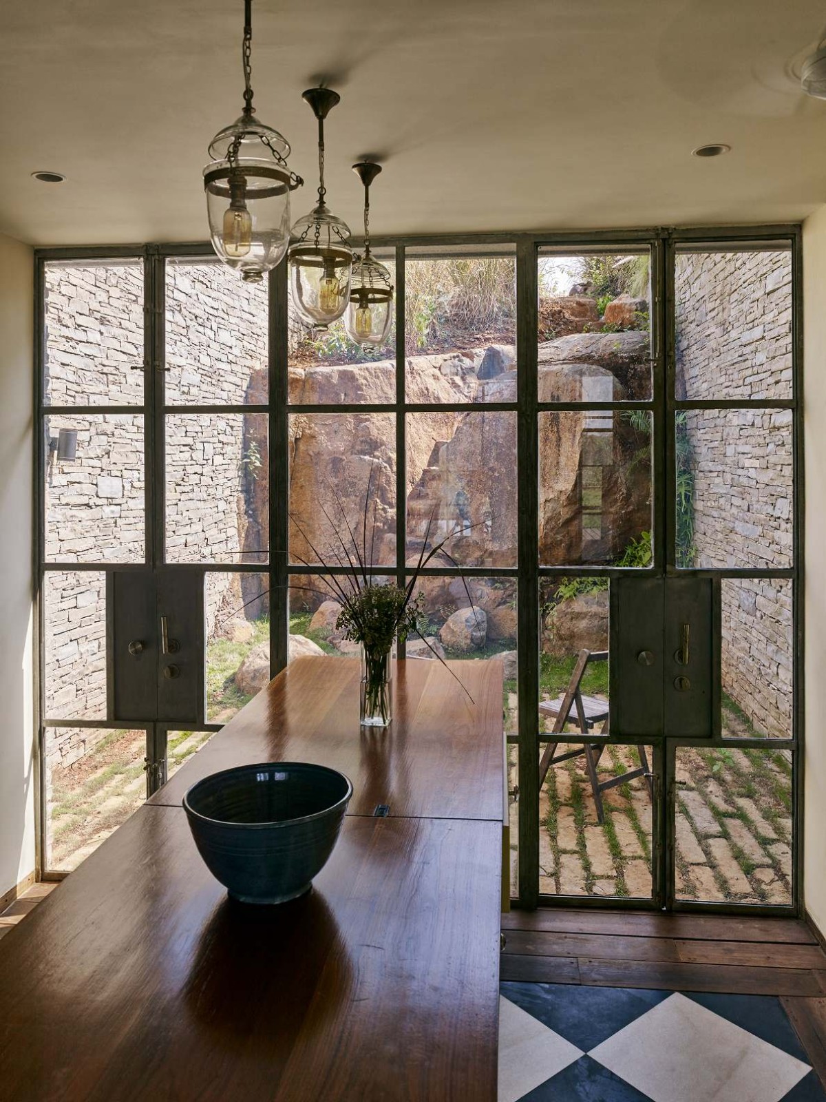 Kitchen opening to courtyard of The Riparian House by Architecture BRIO