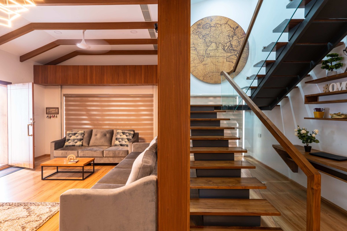 Living area and staircase of Kevin Villa by Nature's Craft Architecture Studio