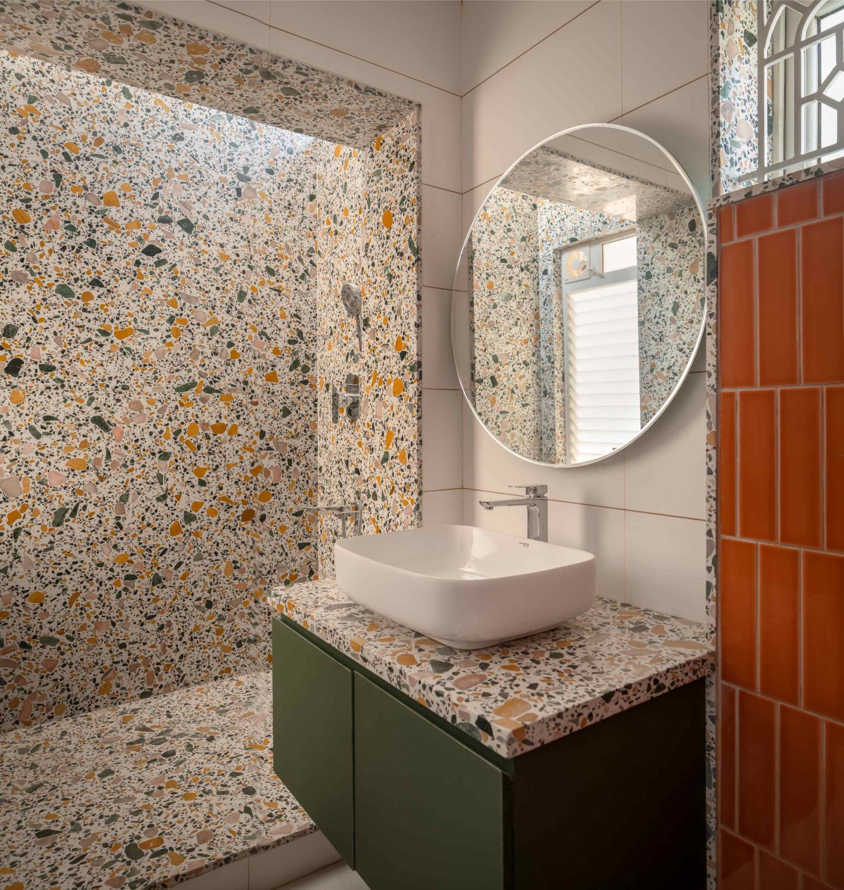 Shot of a bathroom finished in terrazo and orange subway tile