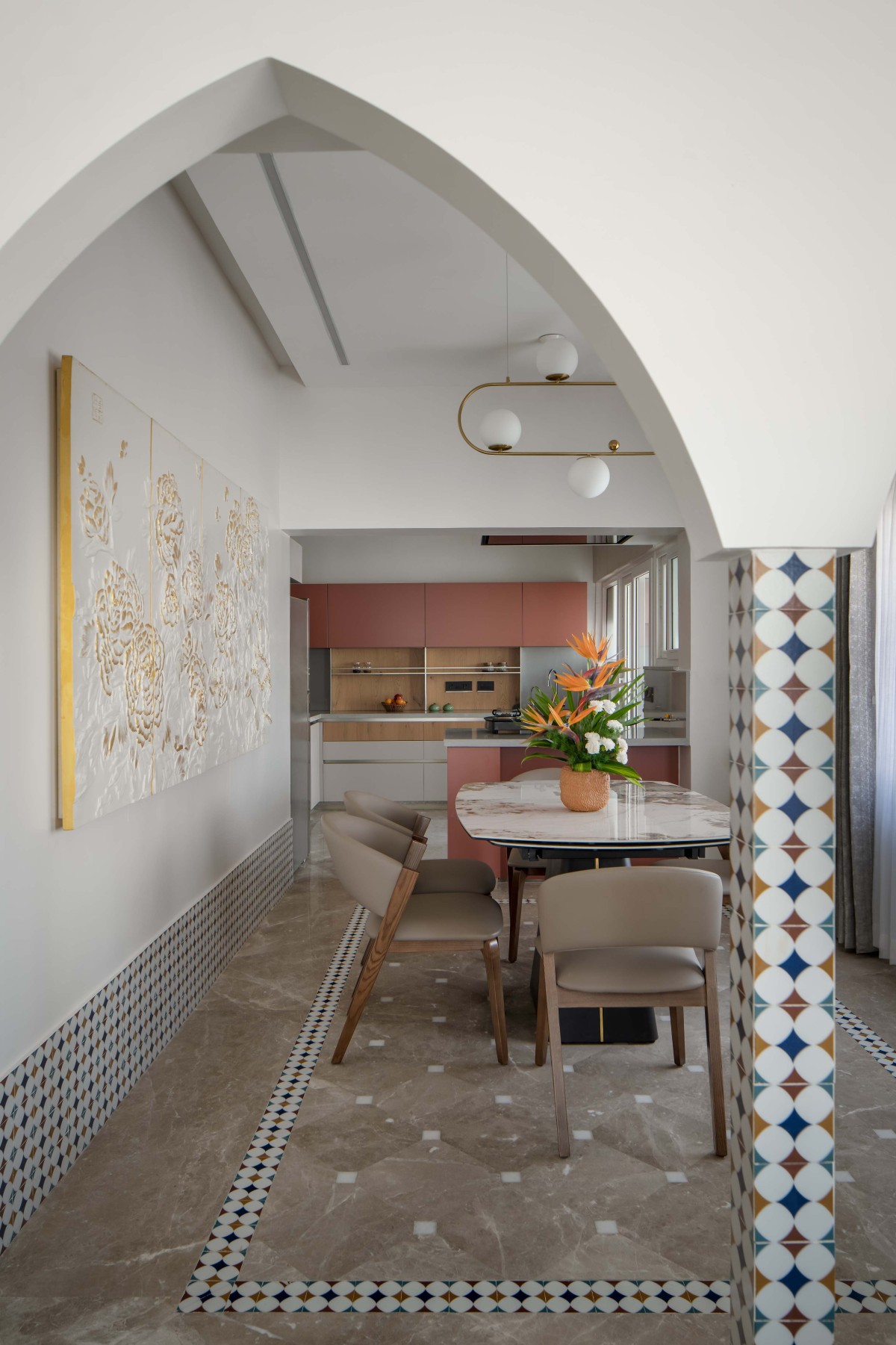 The foyer, dining room, and an open kitchen, delineated by arches and distinct flooring patterns