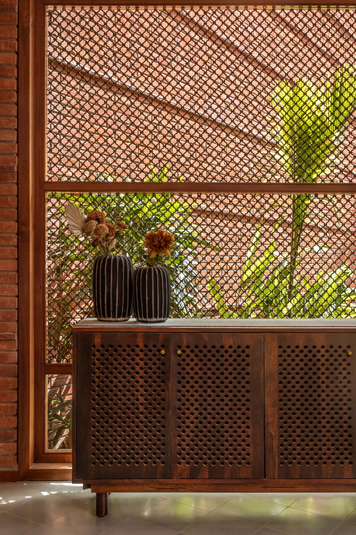 Detailed shot of furniture and wall of Sitish Parikh Farmhouse by Dipen Gada and Associates