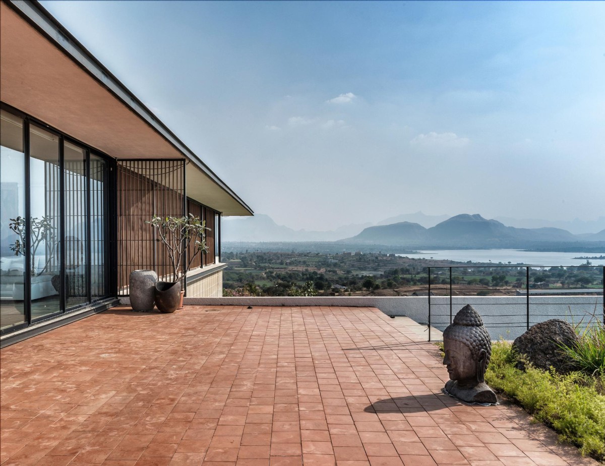 Outdoor deck of House with the Soaring Rock by SPASM Design Architects