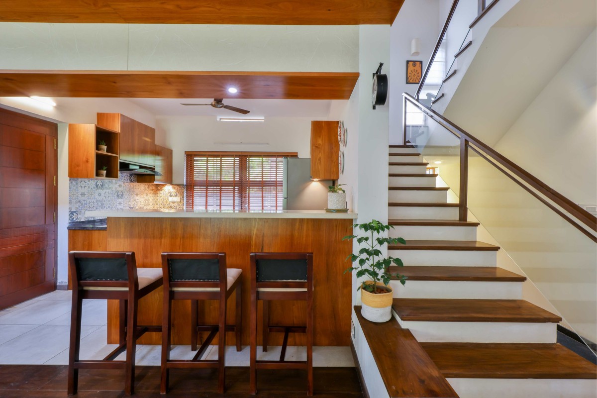 Kitchen and Staircase of Our Space by Satkriya Architecture