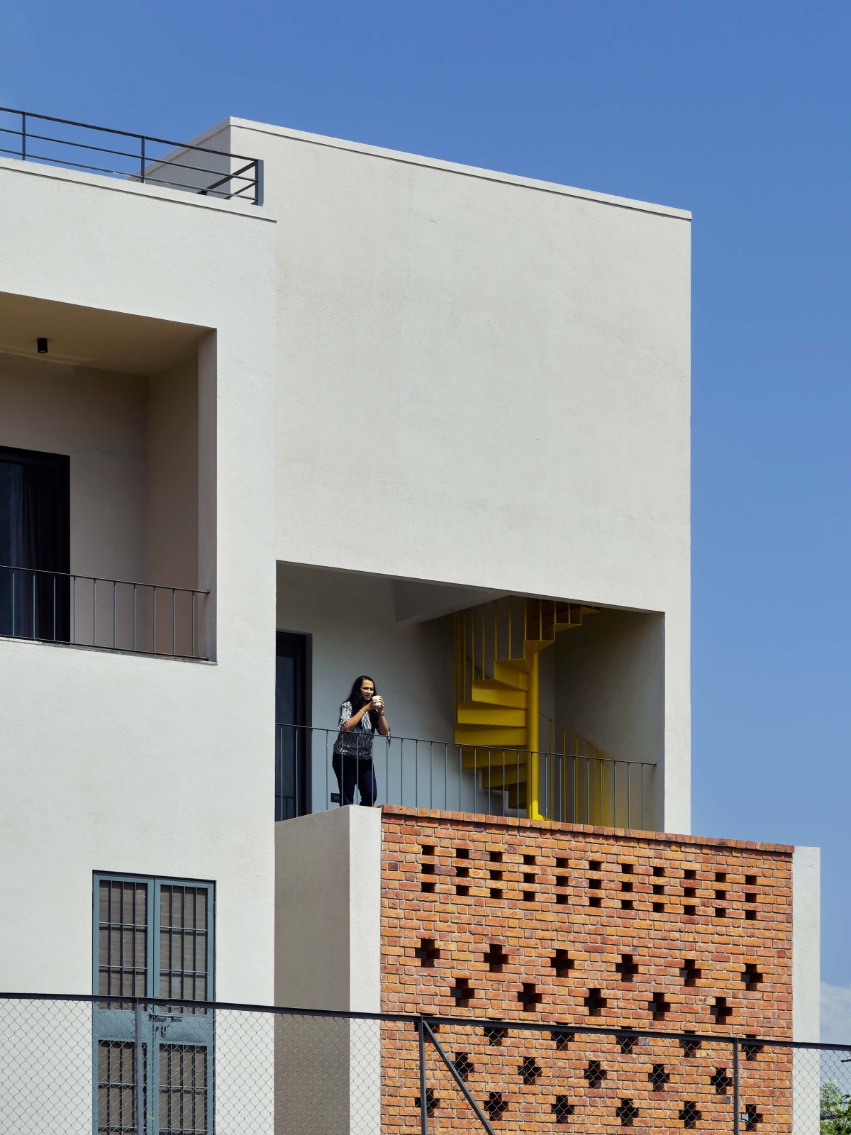 East Side Balcony and Brick Wall of Within Cuboids by Alok Kothari Architects