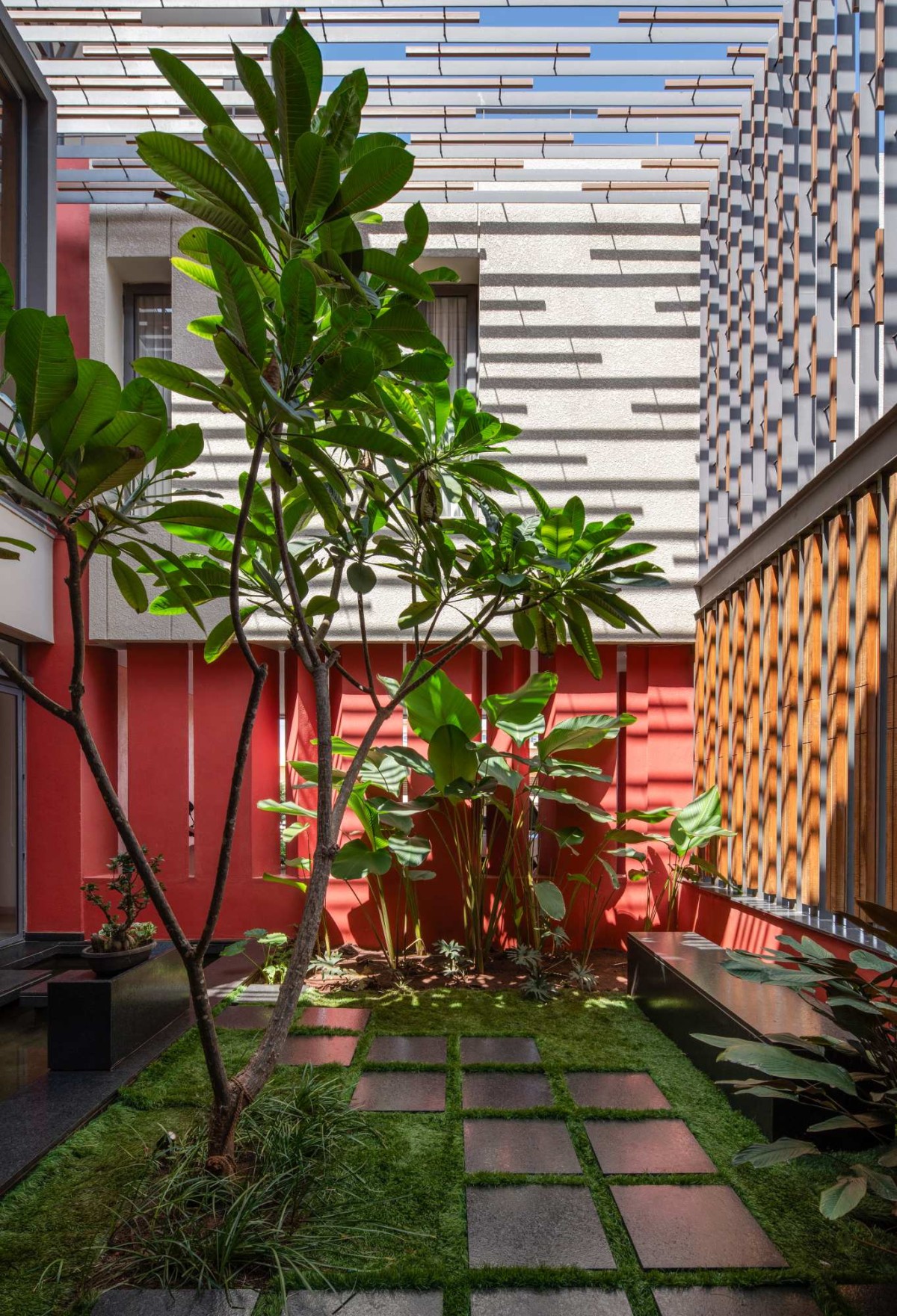 Courtyard shadow play of The Red Courtyard House by Jacob + Rathodi Architects