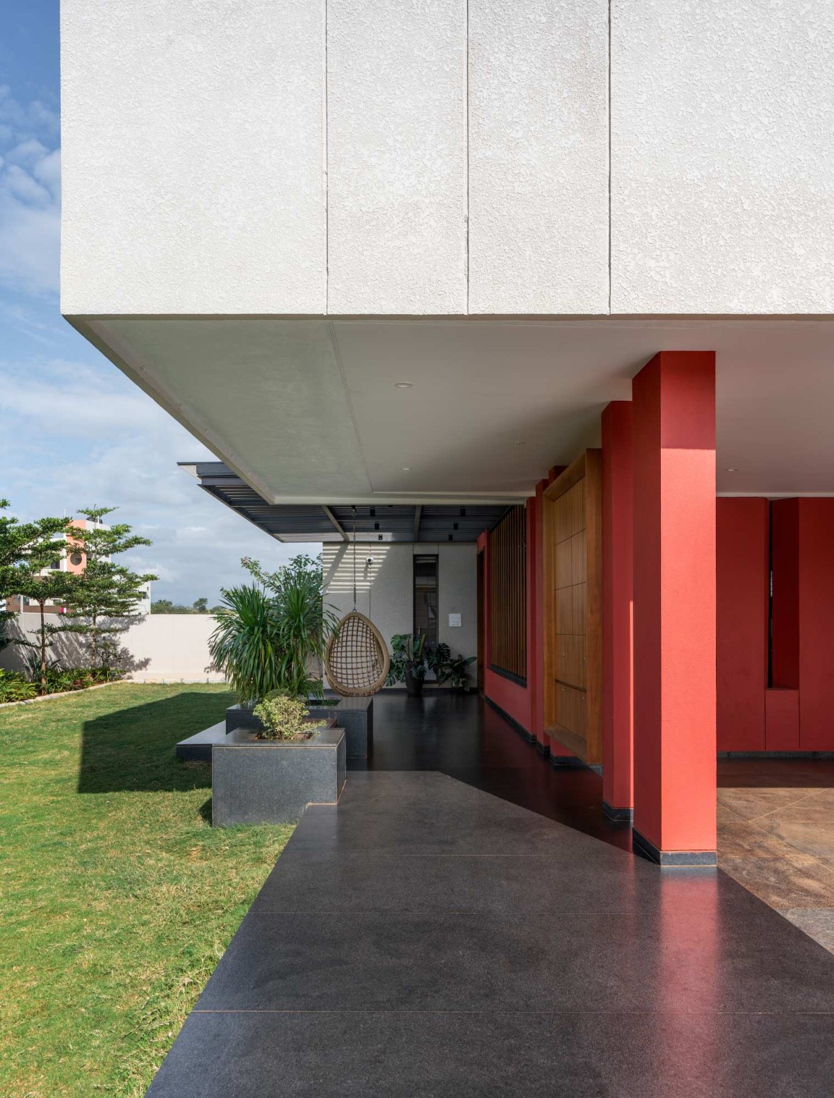 Entrance walkway of The Red Courtyard House by Jacob + Rathodi Architects