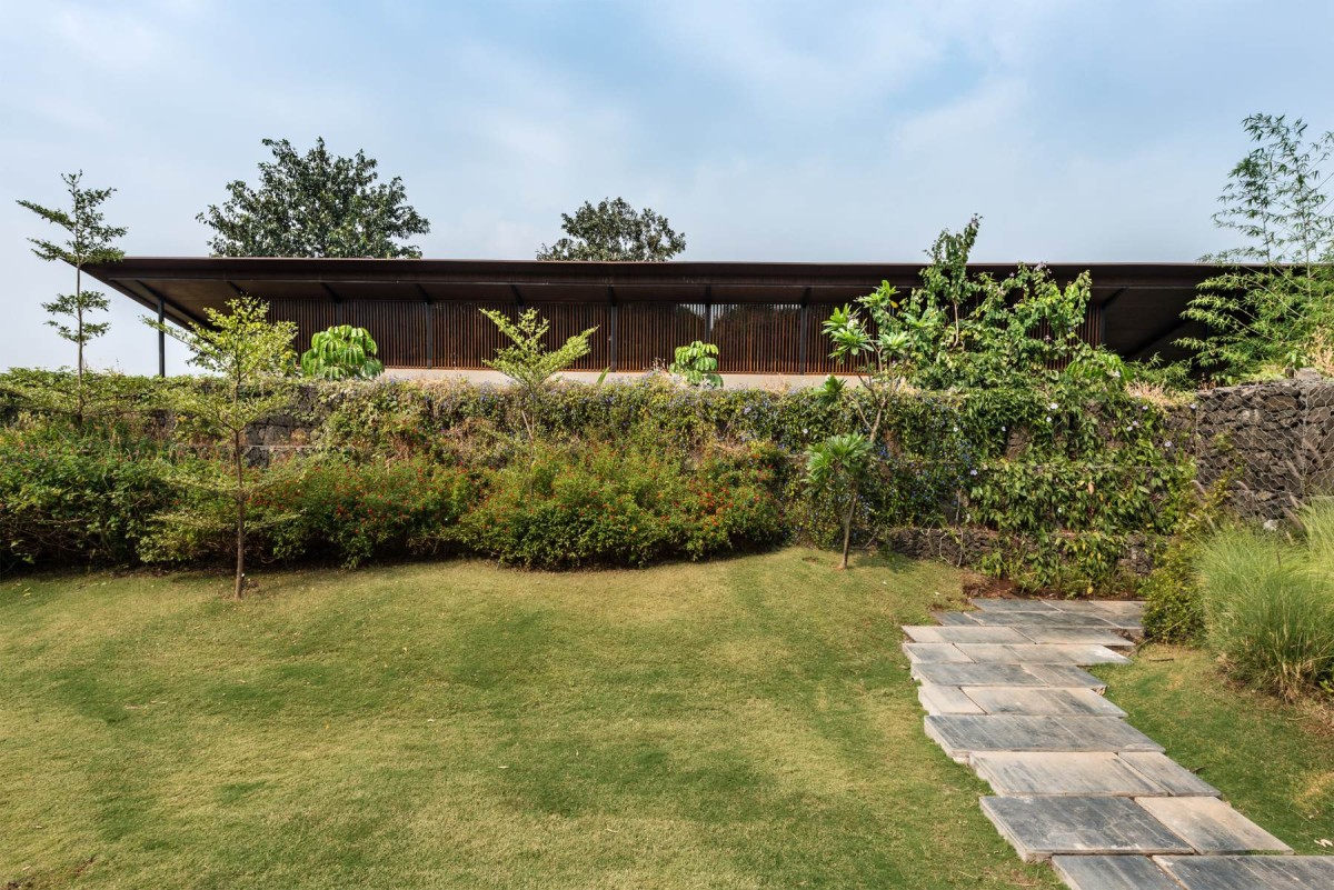 Lawn of The House with the Gabion by SPASM Design Architects