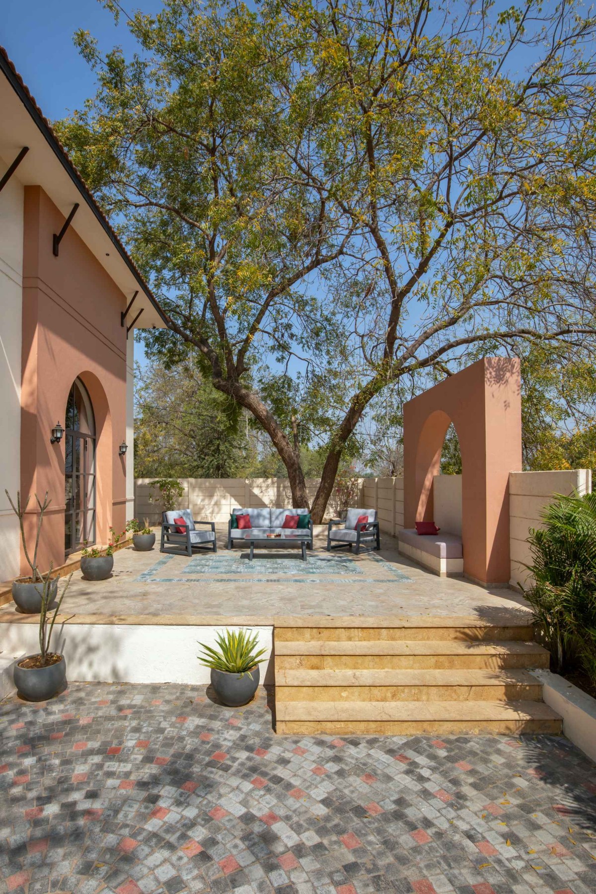 Outdoor courtyard seating of The Bird Song by Alter Architects