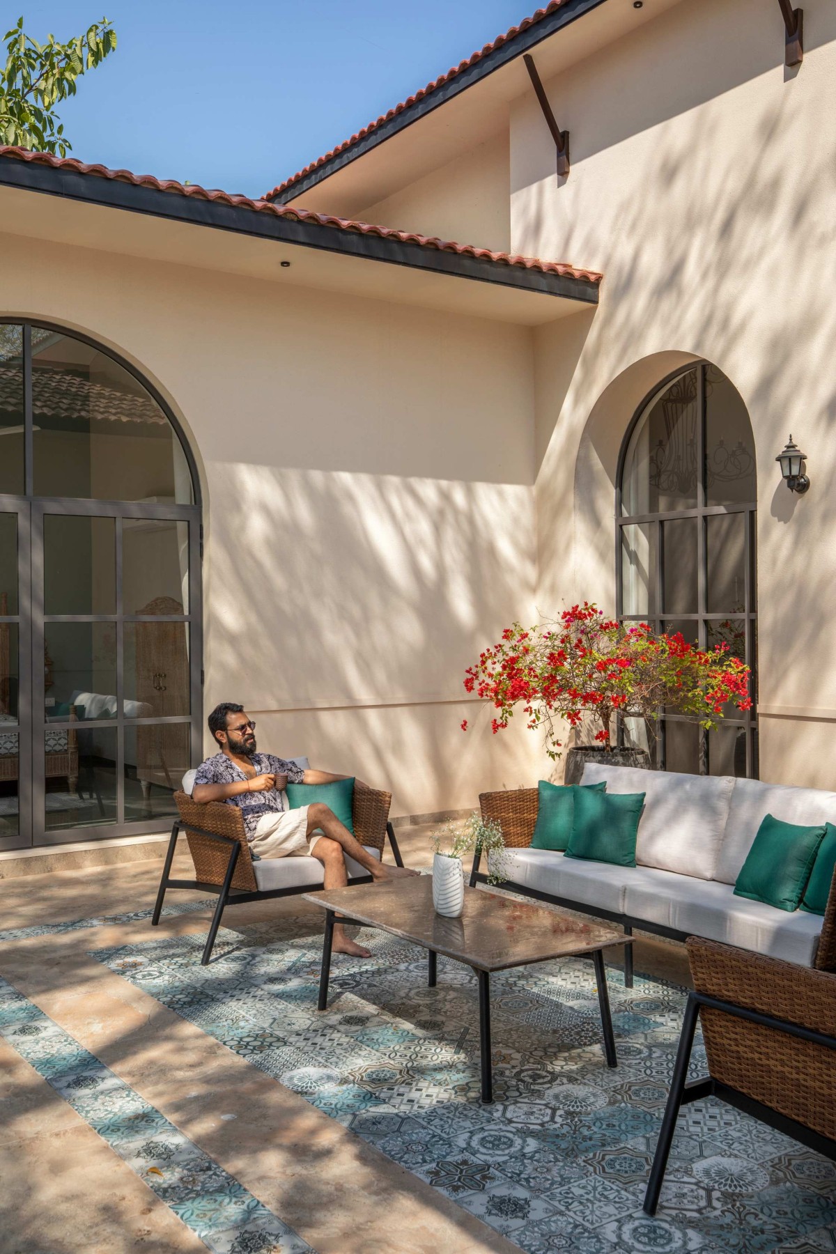 Outdoor seating at pool area of The Bird Song by Alter Architects