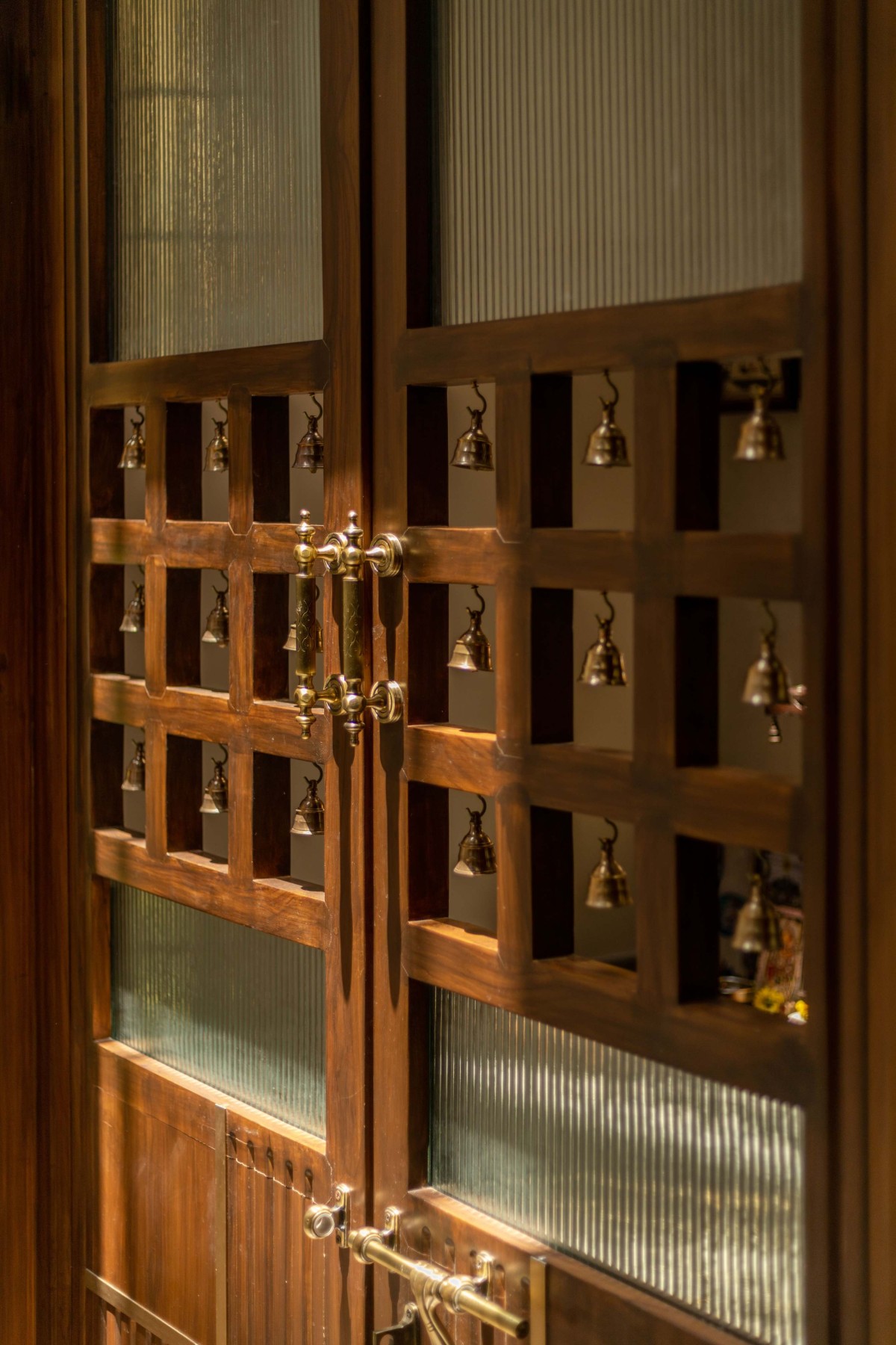 Detailed shot of Mandir door of House of Bare Walls by Bare Wall Studio