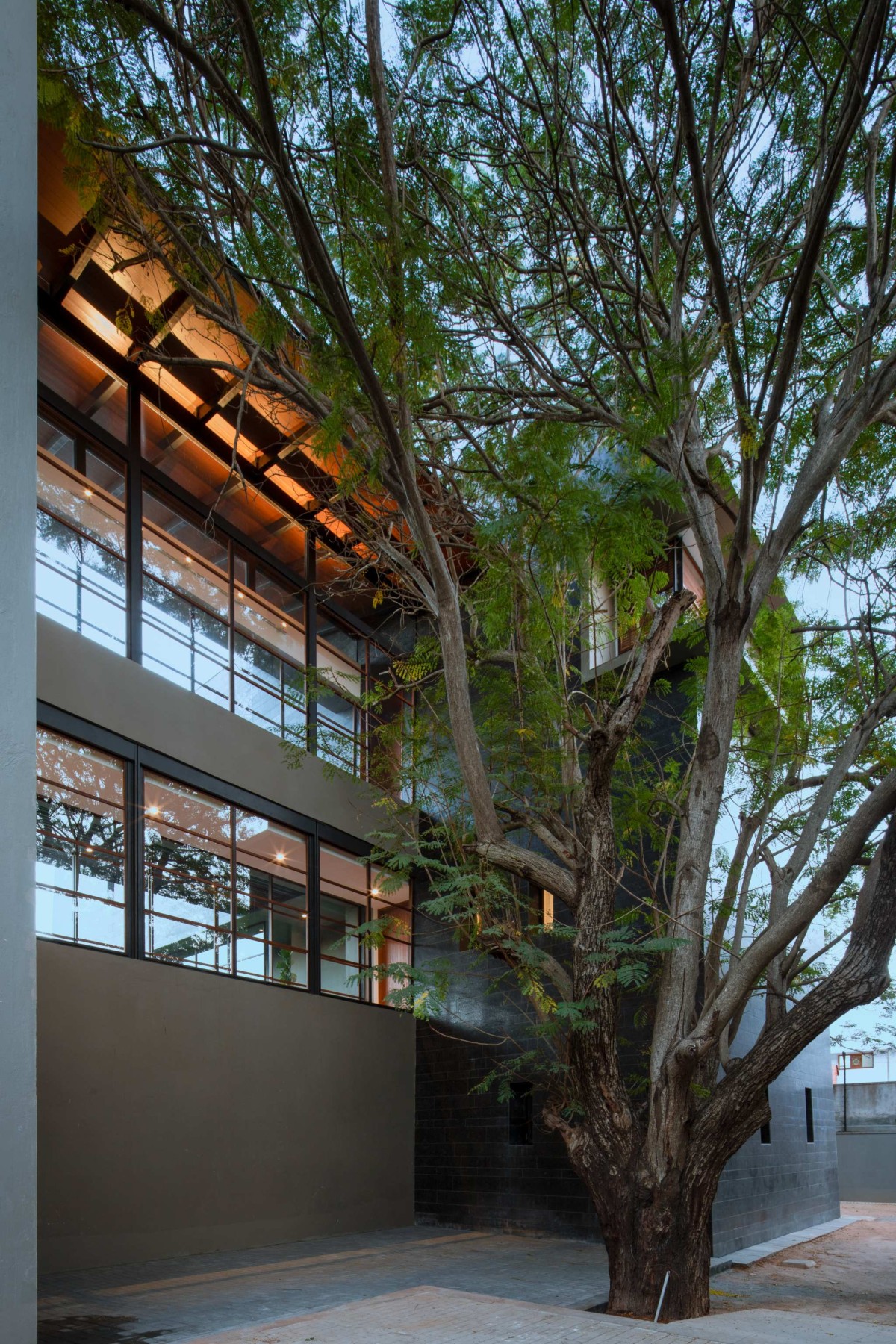 Dusk light exterior view of Black Bastion House by SPASM Design Architects