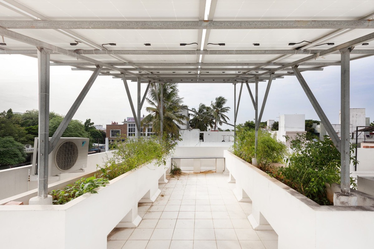 Solar Panel Area with planter of Perforated Plane House by D.L.E.A