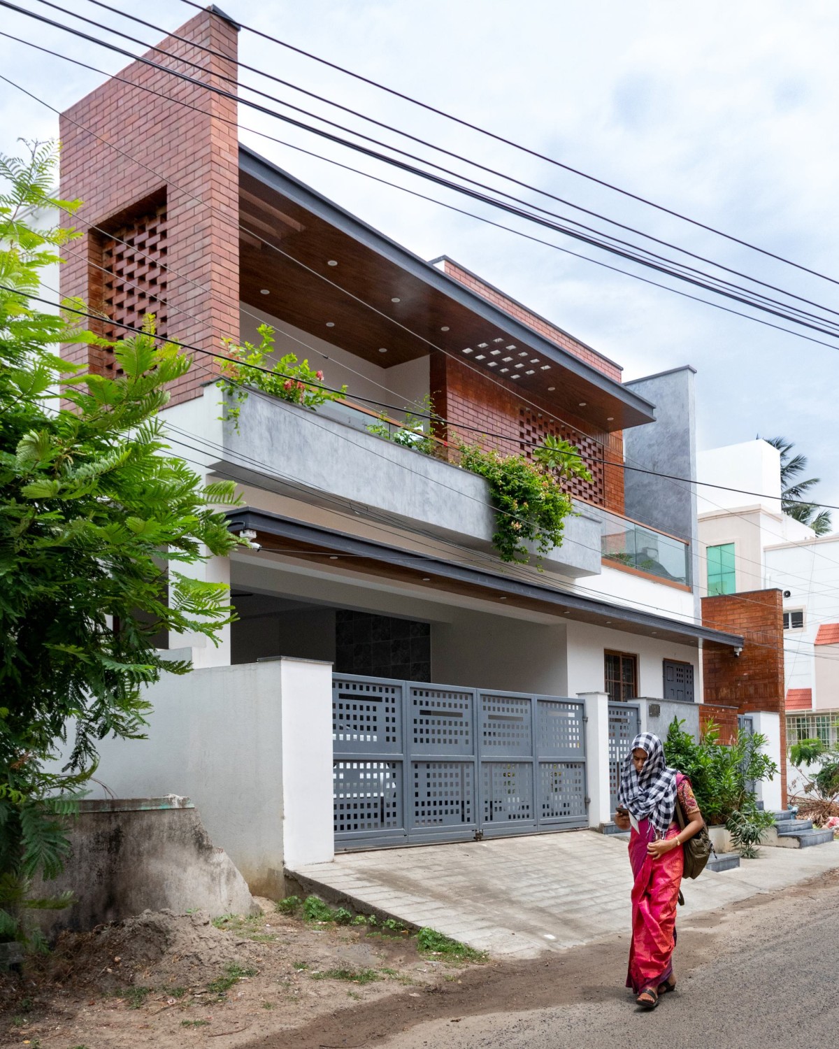 Exterior view of Perforated Plane House by D.L.E.A