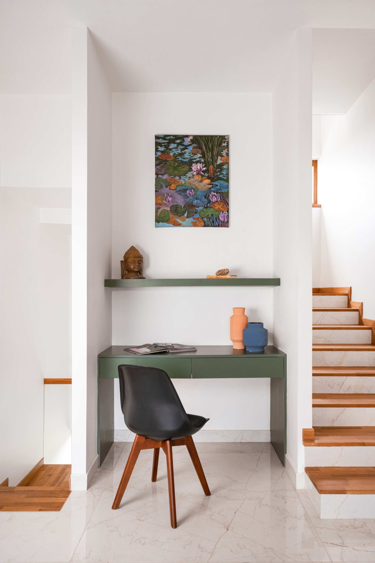 The study nook of colorful accents complements the affluent color theme of the family living adjacent to it