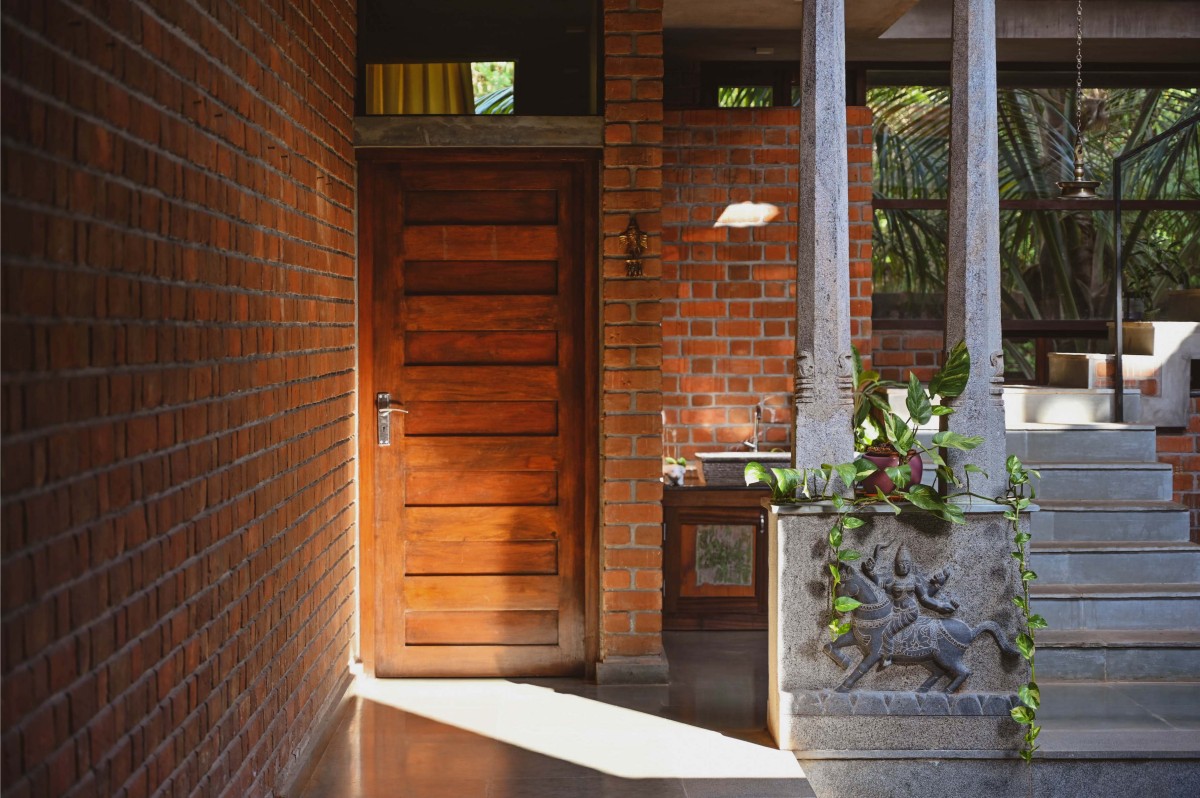 Detailed shot of stone pillars and door of Kalarigram House by Badoloka