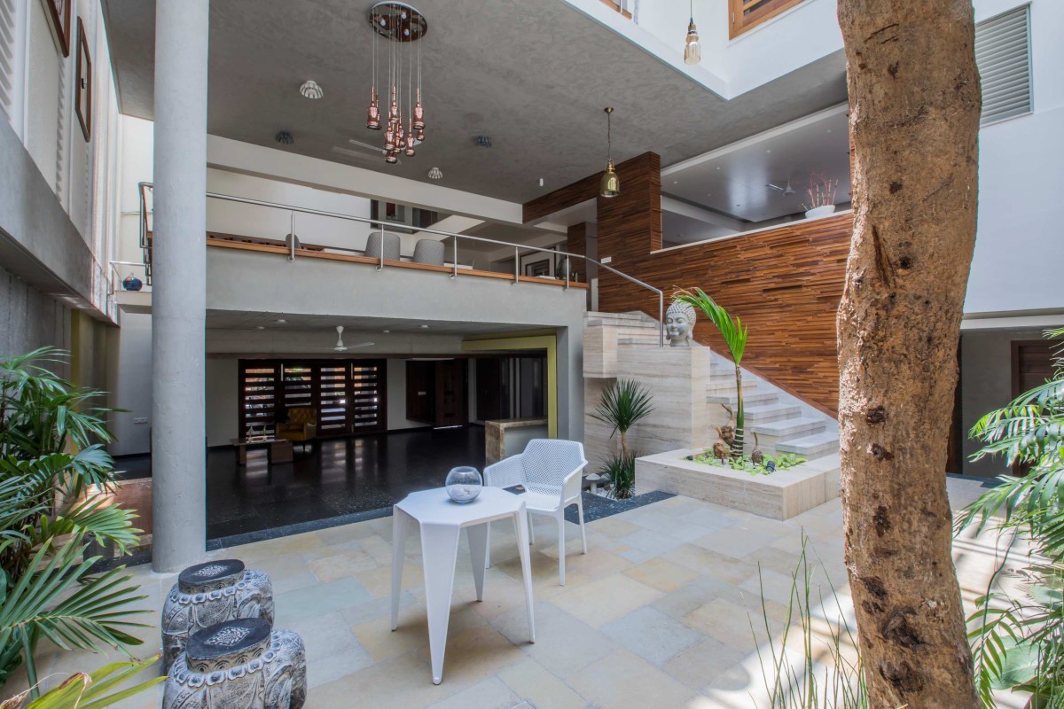 Mango tree courtyad overviewed by the entire section of the house of H2 by Design plus