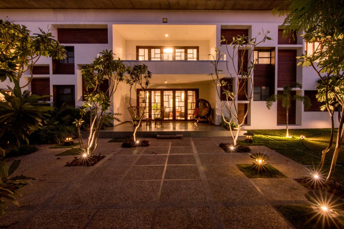 Night exterior view of The Courtyard House by Associated Architects (i) Pvt. Ltd