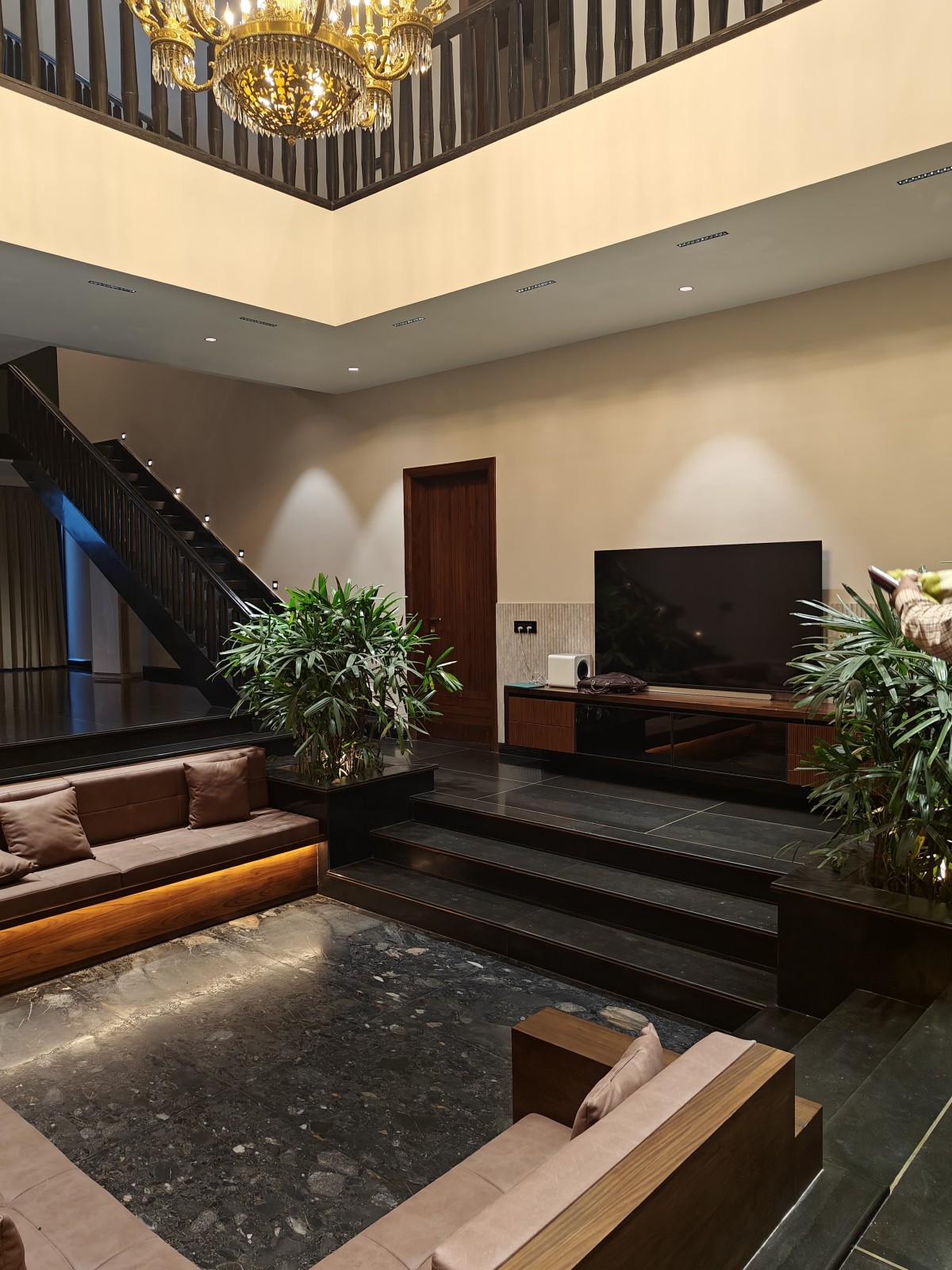 Sunken living of House at Sultanpur Patti by Studio Maroon