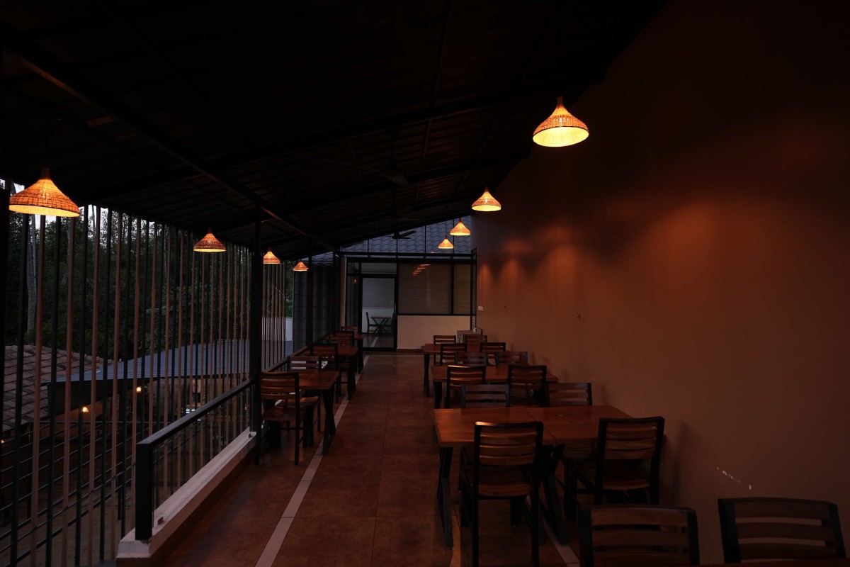 Dusk light view of covered dining space of Manjal - The Portico by Lykke Architecture Studio