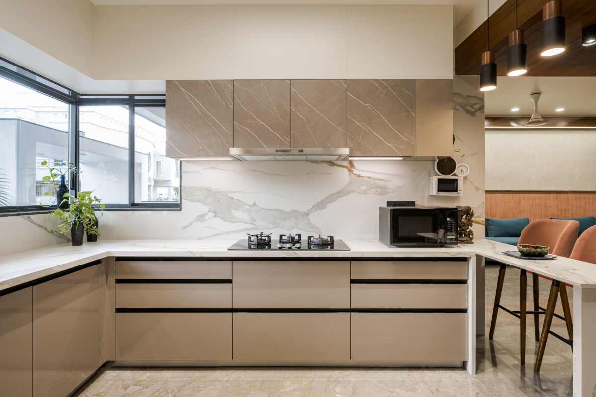 Sober kitchen space with corner window over looking the entrance gate.