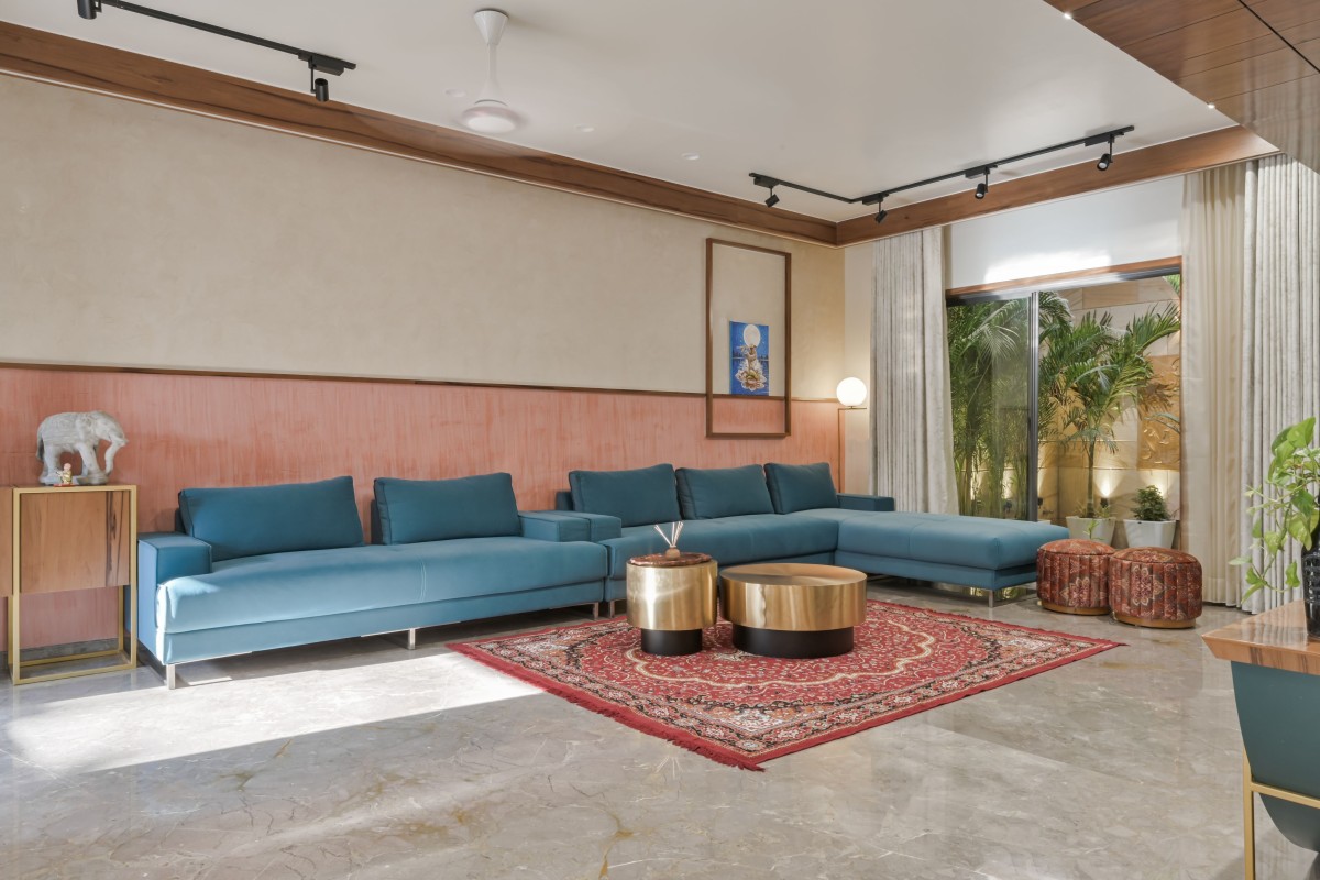 Living room gets impeccable glory with brass centre table and endless grey italian marble with splash of pastels..